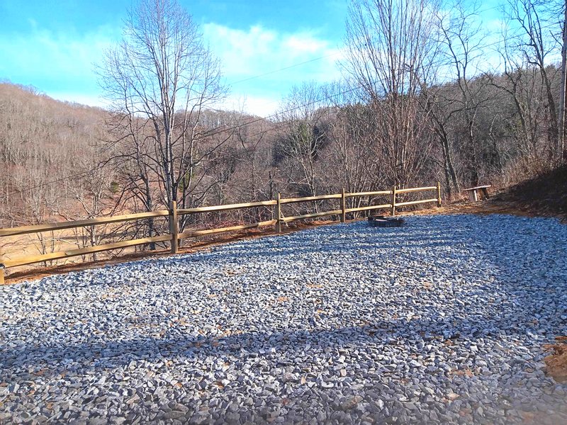 Gravel patio and split-rail fence with mountain views at Ridgetop Retreat