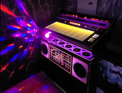 Retro jukebox with colorful lights inside the Highland Hideaways arcade